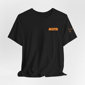 May include: Black t-shirt with an orange logo that says "MSTR" and a small orange graphic on the right sleeve that says "Σ 2104" and "Find".