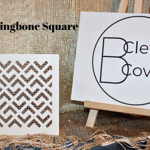 May include: A white wooden square stencil with a herringbone pattern. The stencil is on a gold sparkly surface. The text "Herringbone Square" is visible in the top left corner of the image. The text "Clever Covers" is visible in the top right corner of the image.