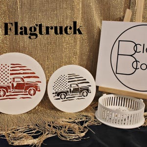 May include: Two white round wooden signs with a red, white, and blue American flag design and a red pickup truck. The text "Flagtruck" is at the top of the image. The text "Clever Covers" is on a white sign behind the wooden signs.