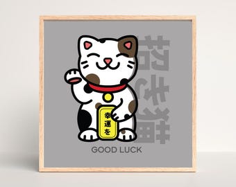 May include: A gray background with a white and brown cartoon cat with a red collar and a yellow sign that says "幸運を" in Japanese. The cat is holding up its right paw and has a happy expression. The text "GOOD LUCK" is below the cat.