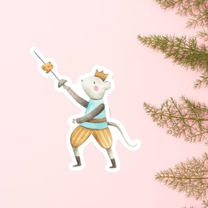 May include: A whimsical sticker featuring a mouse wearing a crown and striped shorts, holding a sword with a piece of cheese on the end. The mouse is in a fencing pose. The background is a soft pink.