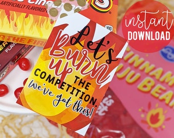 May include: A printable sign with a yellow and red background and the text "Let's burn up the competition. We've got this!"  The sign is surrounded by candy and gum wrappers, including Red Hots, Fire Flavor, and Trident.