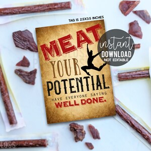 May include: Image of beef jerky sticks and pieces, with a tag that reads "MEAT YOUR POTENTIAL." The tag also includes the text "HAVE EVERYONE SAYING WELL DONE." The tag is 6.35cm x 8.89cm.