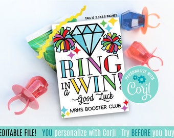 May include: A printable 2.5x3.5 inch tag with a colorful design featuring a diamond, cheerleading pom-poms, and the text "Ring in a Win! Good Luck" with the words "MRHS Booster Club" below. The tag is personalized with the text "Personalize with Corjl".
