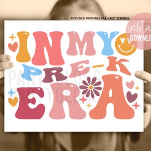 May include: Printable 8x10 inch sign with the text "In My Pre-K Era" in colorful, retro-style letters. The sign is decorated with hearts, stars, and a daisy.