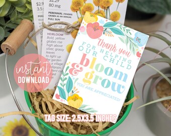 May include: A white card with colorful flowers and the text "Thank you for helping our child bloom & grow. You are appreciated!"  The card is in a green bucket with brown paper shreds. The tag size is 2.5x3.5 inches.