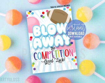 May include: A printable party game card with a blue, white, and pink background. The card features a colorful confetti design and the text "Blow Away the Competition - Good Luck!" in a playful font. The card is 2.5 x 3.5 inches.