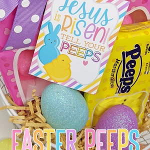 May include: A basket filled with pastel-colored Easter eggs, a box of Peeps marshmallow candies, and a printable tag that reads "Jesus is risen! Tell your peeps".