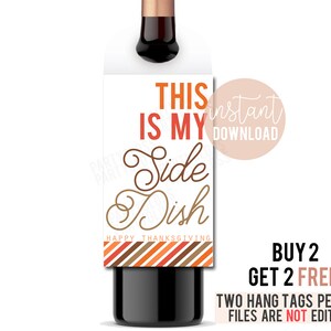 May include: Printable Thanksgiving wine bottle tag with orange, brown, and white stripes. The tag says "This is my side dish. Happy Thanksgiving".