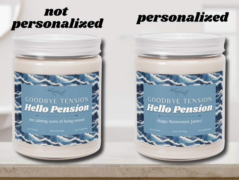 May include: Two white jar candles with white lids. The labels read "Goodbye Tension Hello Pension" with the phrase "the calming scent of being retired" on one and "Happy Retirement James!" on the other. The labels have a blue wave design.