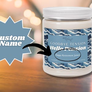 May include: A white jar candle with a white lid. The label features a blue wave design and the text "Goodbye Tension, Hello Passion". The text "Happy Retirement James" is also visible. A blue starburst shape with the words "Custom Name" is in the background.