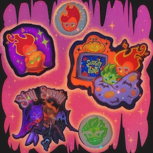 May include: A selection of vibrant Halloween stickers. The designs include cartoon characters with flames, pumpkins, and the phrases "Stay Spooky" and "Scaredy Pants". The colour scheme features orange, purple, and green.