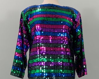 May include: A long-sleeved, sequined top with horizontal stripes in shades of blue, green, pink, and purple.