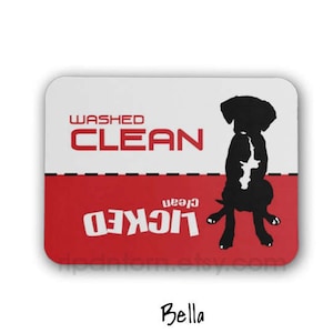May include: A red and white sign with the text "Washed Clean" and "Licked Clean" in black. A black silhouette of a dog is in the center of the sign.