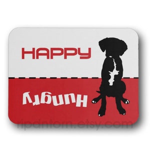May include: A white and red mousepad with a black silhouette of a dog sitting on its hind legs. The text "HAPPY" is in red on the white section and the text "Любин" is in white on the red section.