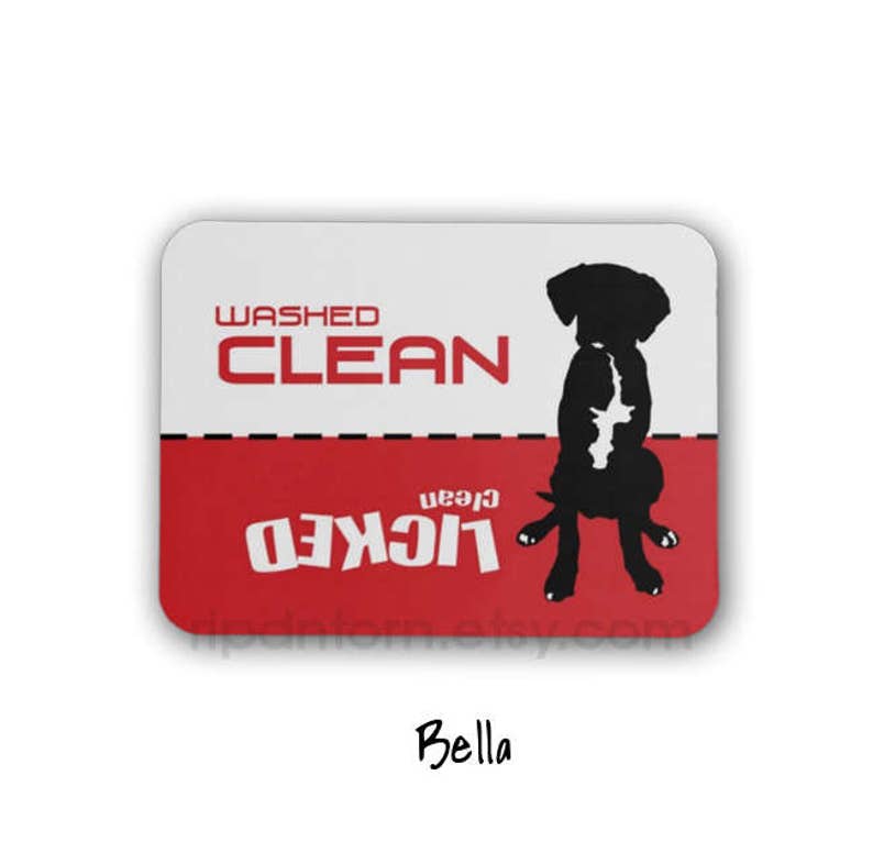 May include: A red and white sign with the text "Washed Clean" and "Licked Clean" in black. A black silhouette of a dog is in the center of the sign.