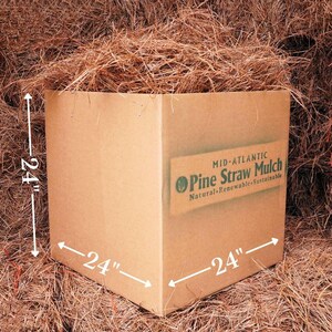 May include: A cardboard box filled with pine straw mulch. The box is 24 inches wide, 24 inches long, and 24 inches high. The box has a label that reads "MID-ATLANTIC Pine Straw Mulch Natural Renewable Sustainable".