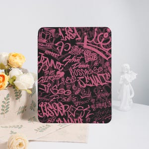May include: A rectangular black and pink graphic design featuring graffiti-style text and illustrations. The design includes words like "Square," "Jennie," and "Shut Down." The overall aesthetic is bold and urban.