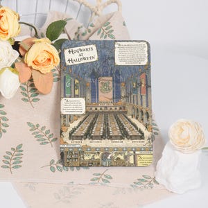 May include: A rectangular book cover with the title "Hogwarts at Halloween" features an illustration of a grand hall with long tables, banners, and text. The cover has a vintage style with a detailed drawing of the interior.