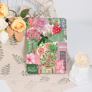 May include: A pink and green illustrated card with the text "Thank You for Being" and "Tiny Louis". The card features a pink telephone box, a pink gummy bear, and various flowers and fruits.