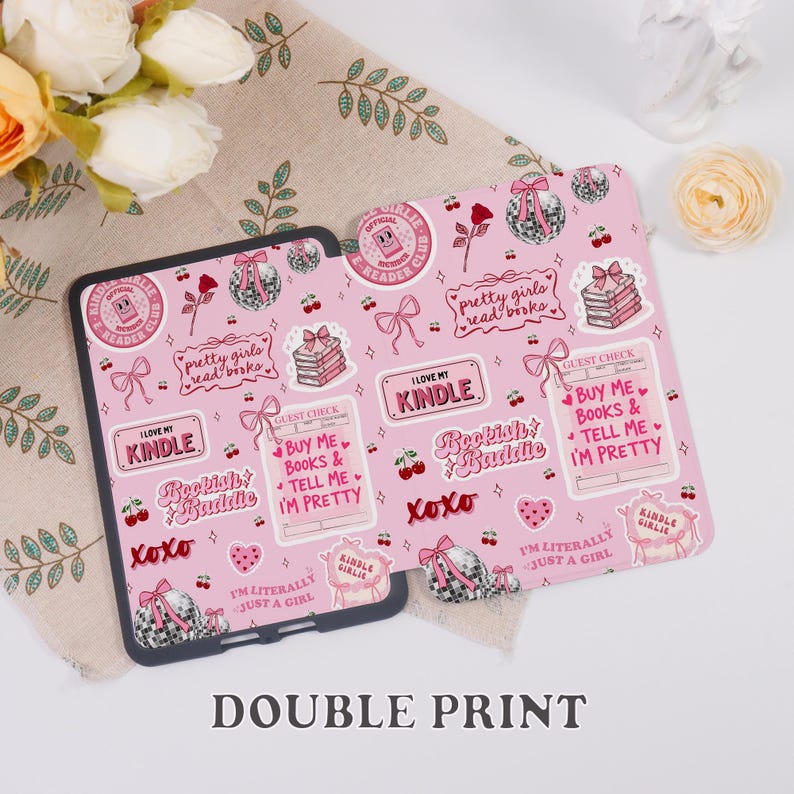 May include: Pink Kindle case with a repeating pattern of bows, books, cherries, and text. The case features phrases like "I love my Kindle", "Bookish Baddie", and "Pretty girls read books". The case is designed for a Kindle.