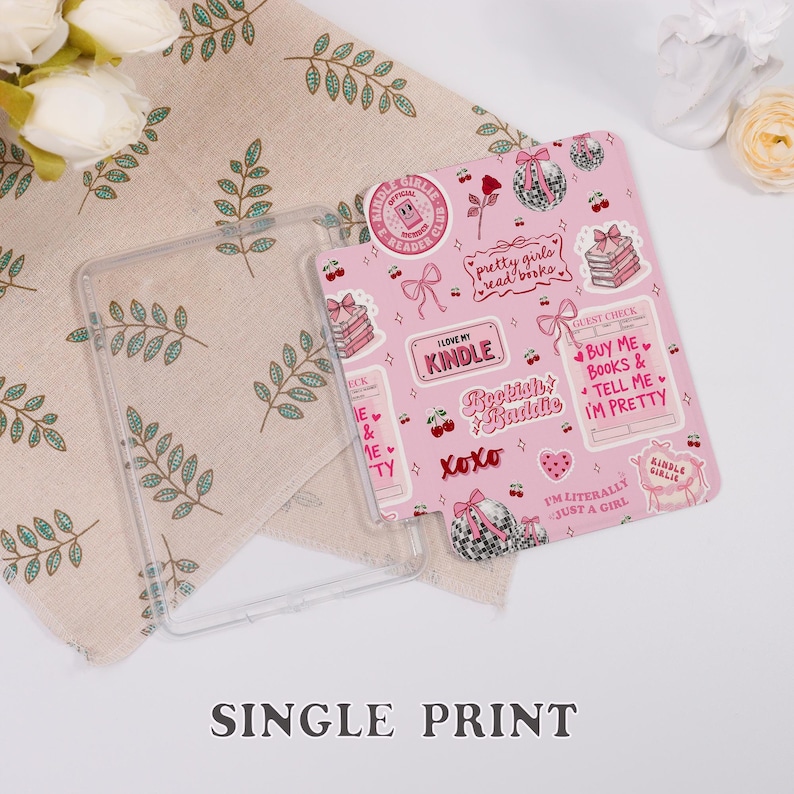 May include: A pink Kindle case decorated with stickers of bows, books, and the phrase "Pretty girls read books." A clear protective case sits beside it. The words "Single Print" are visible at the bottom.