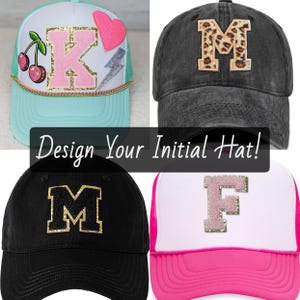 May include: Four baseball caps with initial letters. One cap is black with a gold letter "M", another is gray with a leopard print "M", and two are trucker hats with the letters "K" and "F". The text "Design Your Initial Hat!" is in the center.