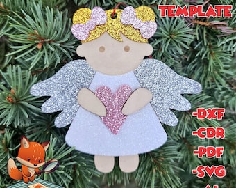 May include: Laser cut angel ornament with glitter wings, a pink heart, and gold hair bows. The ornament is ready to be assembled and decorated. The image includes the text "Laser Ready Template" and file formats: DXF, CDR, PDF, SVG, AI.