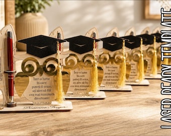 May include: A row of wooden owl-shaped desk organizers featuring a black graduation cap with a gold tassel. Each owl has a gold mirror finish belly with Romanian text and a red pen held in a feather-shaped side stand on a flat wooden base.