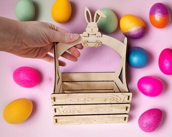 May include: A wooden Easter basket with a bunny rabbit cutout on the handle. The basket is empty and surrounded by colorful Easter eggs.