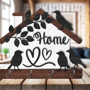 Pode incluir: Porta-chaves de madeira em forma de casa com a palavra "Home" e recortes de coração. Possui quatro ganchos e pássaros e folhas pretas decorativas. O texto "LASER READY TEMPLATE" está no canto superior esquerdo.