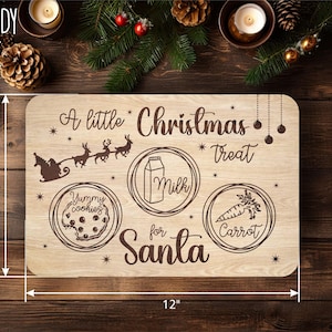 Op de afbeelding: Een houten bord met de tekst "A little Christmas treat for Santa" en drie illustraties: een bord met koekjes, een glas melk en een wortel. Het bord is 30,5 cm breed en 20,3 cm hoog.