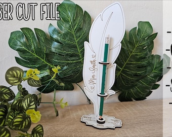 May include: Laser cut file for a teacher gift, featuring a white feather with a pencil holder and the text "Mrs. Smith" and "Best Teacher Ever 2025". The file is available in DXF, CDR, PDF, SVG, and AI formats.