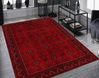 May include: A rectangular area rug featuring a deep red base color with intricate black geometric patterns and diamond-shaped motifs. The rug has a wide border with a repeating wave-like line design and a thin inner frame of small black squares.