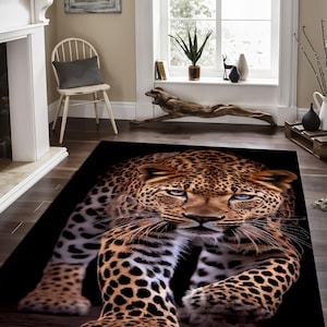 May include: A close-up of a brown and black leopard rug with a black background. The leopard is walking towards the viewer with its head held high and its eyes open.