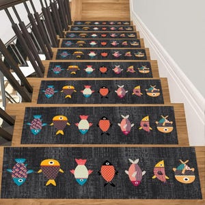 May include: A set of rectangular stair treads featuring a dark gray textured background with a repeating pattern of colorful, stylized fish in shades of orange, blue, pink, and yellow, arranged horizontally across each individual stair runner.