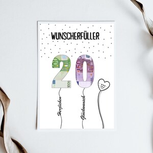 May include: A white card with black polka dots and the text "Wunschersch&uuml;ller 20" in black. The numbers 20 are made of euro bills and are attached to strings with the words "Herzlichen" and "Gl&uuml;ckwunsch" written on them.