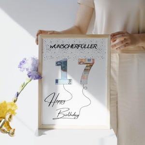 May include: A white framed print with the text "Wunscherschfuller" and the number "17" made of money bills. The text "Happy Birthday" is written below the number.
