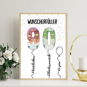 May include: A framed print with the text "WUNSCHERF&Uuml;LLER" at the top. The number "90" is designed as balloons filled with Euro banknotes. The words "Herzlischen", "Gl&uuml;ckwunsch", and "to you" are written in cursive below the numbers. Confetti dots the background.