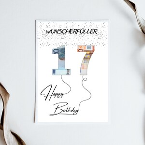 May include: A white card with black text that says "Wunschersch&uuml;ller" and "Happy Birthday". The number 17 is made of euro bills and is floating like balloons.