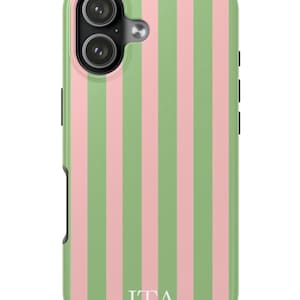 May include: A phone case with a vertical striped pattern in light green and pink. The case has a camera cutout and the initials "JTA" in white at the bottom. The case is designed to protect the phone from damage.
