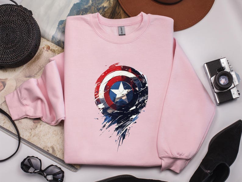 a pink sweatshirt with a captain america design on it