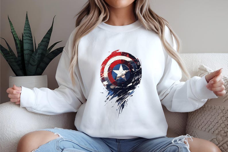 a woman sitting on a couch wearing a captain america sweatshirt