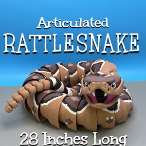 May include: An articulated rattlesnake toy measuring 28 inches long. The snake features a brown and tan patterned body with a textured surface, a wide open mouth with visible fangs, and a segmented tail. The text reads Articulated RATTLESNAKE.