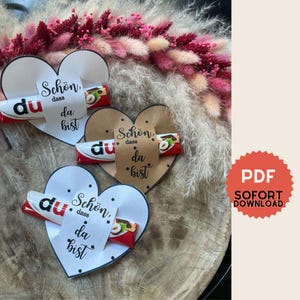File di stampa delle fascette a forma di cuore Duplo in formato PDF: design minimalista, "È bello che tu sia qui. Come decorazione da tavola, regalo per gli ospiti, Pasqua, eventi
