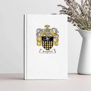 May include: A white book with a black and yellow coat of arms featuring a checkered shield and the text "Antolini".