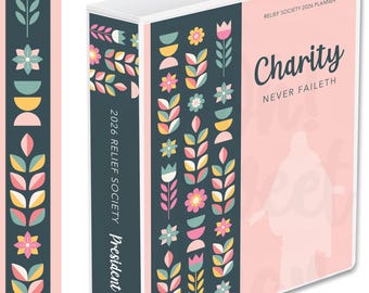 Op de afbeelding: Een 2026 Relief Society planner met een roze en teal bloemenontwerp. De omslag bevat de woorden "Charity Never Faileth" en een silhouet. De rug leest "2026 Relief Society President".