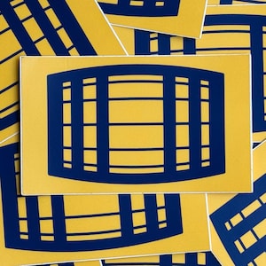 May include: A collection of rectangular stickers featuring a bold, dark blue graphic of a barrel silhouette centered on a vibrant yellow background. The design consists of vertical and horizontal lines forming a grid pattern that mimics barrel staves.