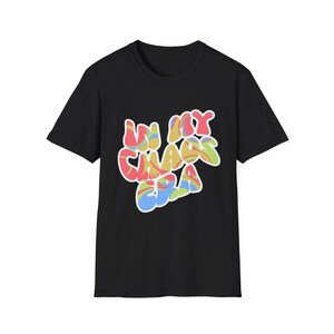 May include: Black t-shirt with the text "In My Chaos Era" in a colorful, bubble-style font. The text features a mix of red, yellow, blue, and green colors. The shirt is a classic crew neck style.
