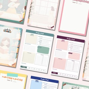 May include: A collection of stationery items, including notepads and project pads, with a soft, pastel color palette. Some pads feature the text "made to teach" and "make today a good day". The project pads have sections for goals, action steps, and expenses.
